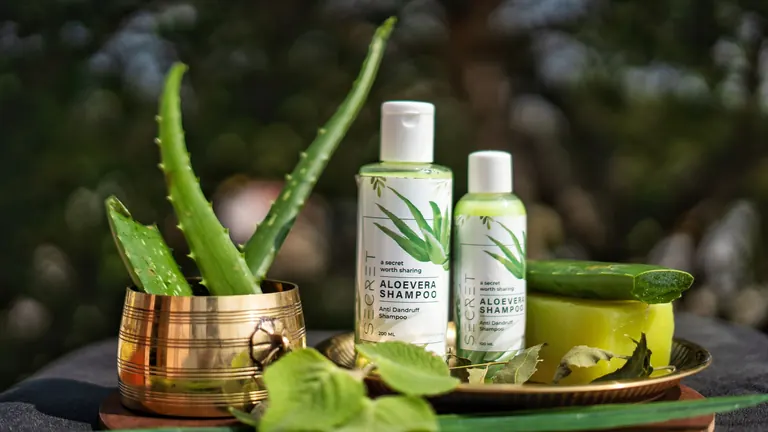 Listy aloe vera vedle přírodní kosmetiky jako symbol přírodních lubrikantů